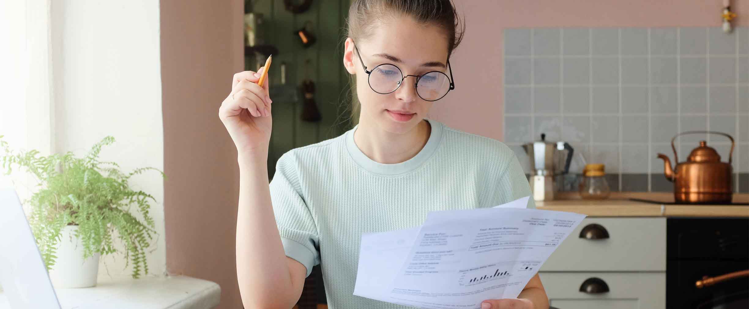 Indoor picture of young European female sitting at home at table stock photo