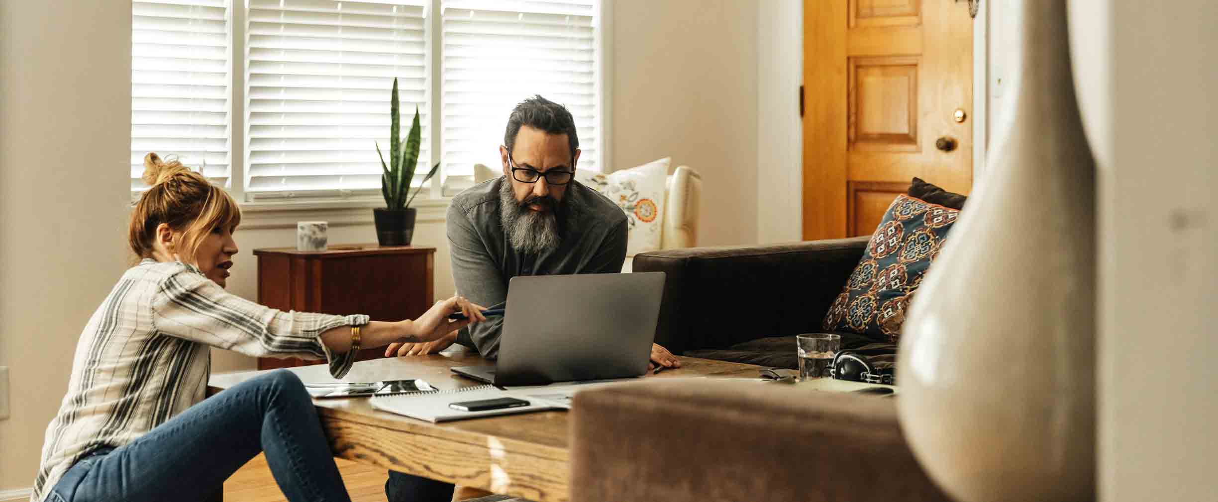 A couple in their living room planning their investments together.