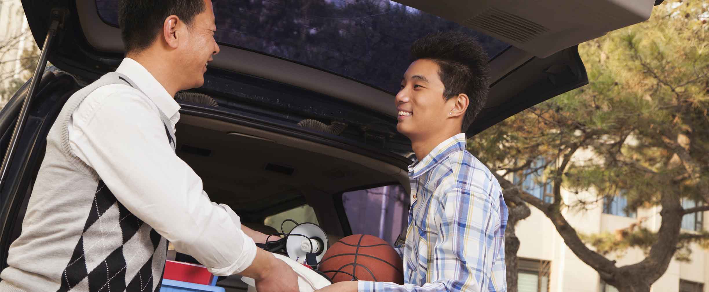 father helping son unpack his things at college