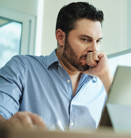 Worried Businessman Looking at Laptop Computer