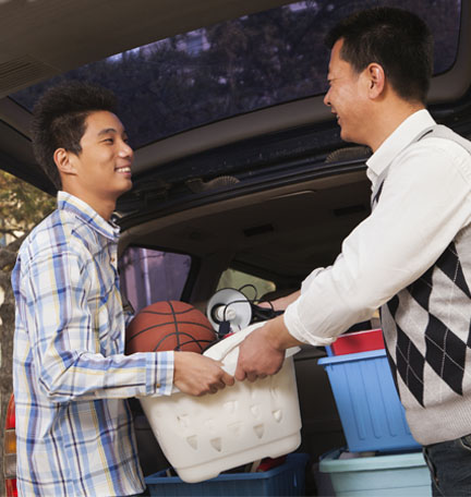 father helping son unpack his things at college